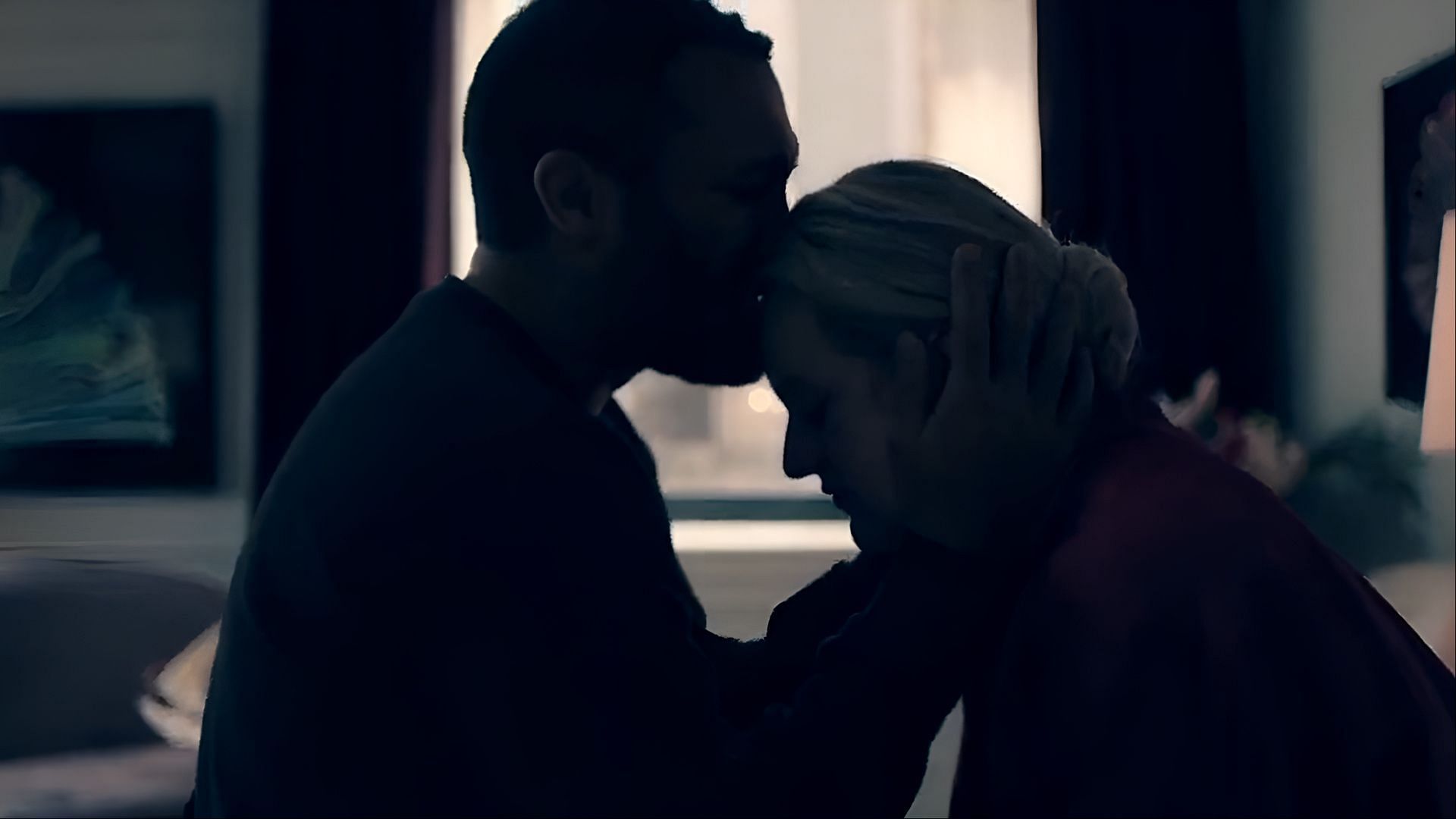 Luke comforts June with a final gesture of love before they go their separate ways, their split setting the stage for The Testaments' emotional legacy (Image via Hulu)
